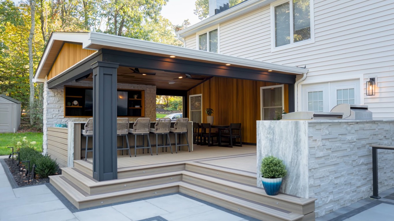 Custom outdoor deck with built-in kitchen and dining area